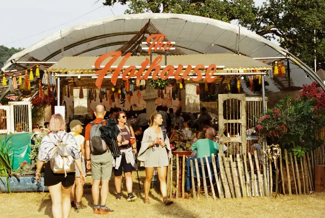 Crowds at the hothouse festival bar under lit canopy